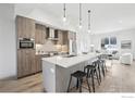Modern kitchen with a large center island, pendant lighting, stainless appliances, and open concept to living area at 2909 32Nd St, Boulder, CO 80301