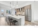 Modern kitchen with a large island, pendant lighting, stainless steel appliances, and sleek wood cabinetry at 2909 32Nd St, Boulder, CO 80301
