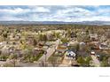A high aerial shot shows neighborhood with mountain views in background at 3001 Chase St, Wheat Ridge, CO 80214