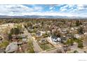 A high aerial shot shows neighborhood with mountain views in background at 3001 Chase St, Wheat Ridge, CO 80214