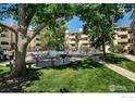 Community pool area with seating, BBQ grill, and lush landscaping, ideal for relaxation and entertainment at 3035 Oneal Pkwy # T, Boulder, CO 80301