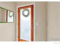Inviting entryway with frosted glass door featuring a decorative wreath and sleek wood frame at 3174 Foundry Pl, Boulder, CO 80301