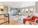 Bright living room featuring hardwood floors, modern furniture, and large windows showcasing a serene view at 3174 Foundry Pl, Boulder, CO 80301