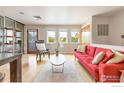 Sunlit living room with hardwood floors, a red sofa, and stylish accents for comfortable living at 3174 Foundry Pl, Boulder, CO 80301