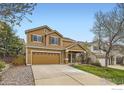 View of the home's curb appeal with a spacious driveway, a well-manicured lawn and mature trees at 3617 Blanca Peak Dr, Superior, CO 80027