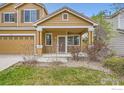 Close-up of the front porch, showcasing the entryway, columns, and garden in front of home at 3617 Blanca Peak Dr, Superior, CO 80027