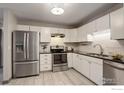 Well-lit kitchen features modern appliances and white cabinets at 3785 Birchwood Dr, Boulder, CO 80304