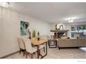 Living area with natural light, open fireplace, and dining table at 3785 Birchwood Dr, Boulder, CO 80304