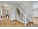 Bright entryway featuring hardwood floors, carpeted stairs, and natural light at 4251 Peach Way, Boulder, CO 80301