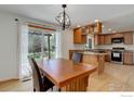 Eat-in kitchen with wood cabinets, granite countertops, and backyard view at 4251 Peach Way, Boulder, CO 80301