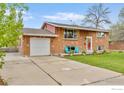Lovely brick home with an attached garage and inviting curb appeal at 4544 W 65Th Ave, Arvada, CO 80003