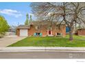 Inviting brick home with a well-manicured lawn, perfect for outdoor enjoyment at 4544 W 65Th Ave, Arvada, CO 80003