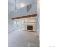 Spacious living room with fireplace, high ceilings and adjacent access to the outdoors at 4877 Darwin Ct, Boulder, CO 80301