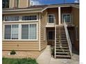 Exterior view of a two-story condo with stairs, balcony, and natural light at 6036 Gunbarrel Ave # B, Boulder, CO 80301