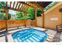 Community hot tub featuring wood pergola, shade, and beautiful landscaping at 6036 Gunbarrel Ave # B, Boulder, CO 80301