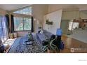 Comfortable living room with large windows, modern decor, and a view of the outside landscape at 6036 Gunbarrel Ave # B, Boulder, CO 80301