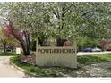 Community sign for Powderhorn with mature landscaping and walking path creating a welcoming entrance at 6036 Gunbarrel Ave # B, Boulder, CO 80301