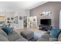 Comfortable living room featuring an open floorplan and flows into the kitchen and dining area at 803 W Lucerne Dr, Lafayette, CO 80026