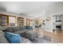Bright living room with open floor plan, hardwood floors, neutral paint, and modern decor at 803 W Lucerne Dr, Lafayette, CO 80026