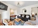Open living room with desk, hardwood floors, modern lighting, and access to the bedroom at 8050 Niwot Rd # 31, Niwot, CO 80503