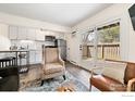 Living room and kitchen area with hardwood floors and access to the patio at 8050 Niwot Rd # 31, Niwot, CO 80503