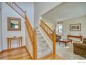 Bright foyer boasts wood floors, staircase, and seamless access to the living area, creating an inviting and open atmosphere at 8574 W 94Th Ave, Westminster, CO 80021