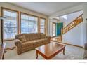 Inviting living room is enhanced by a large window and views and a seamless transition to the entry foyer at 8574 W 94Th Ave, Westminster, CO 80021