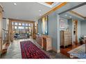 Inviting foyer boasts tile flooring, wood trim, natural light and opens to the living room at 8912 Little Raven Trl, Niwot, CO 80503