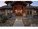 Charming front entrance with stone accents, a covered porch, and steps to the front door at 8912 Little Raven Trl, Niwot, CO 80503