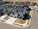 An aerial view of a bright, modern two-story home with a three-car garage on a corner lot at 904 Sundown Way, Erie, CO 80516