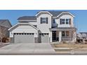 Charming two-story home with a three-car garage, stone accents, and well-maintained landscaping at 904 Sundown Way, Erie, CO 80516
