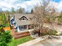 Aerial view of a well-maintained blue two-story home with lovely landscaping at 945 Lincoln Ave, Louisville, CO 80027