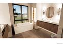 A modern bathroom featuring a soaking tub, floating double sink vanity, and black-trimmed windows at 9578 Mountain Ridge Dr, Boulder, CO 80302
