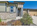 Close-up of the front entry with attractive stone detail and covered entryway at 10834 Graphite St, Broomfield, CO 80021