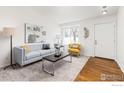 Inviting living room with neutral tones, artful decor, and plenty of natural light at 1507 Begonia Way, Superior, CO 80027