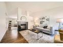 Bright living room with a stylish fireplace, hardwood floors, and modern decor for comfortable living at 1507 Begonia Way, Superior, CO 80027