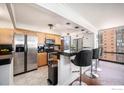 Kitchen with a breakfast bar, stainless steel appliances, and a view at 1625 Larimer St # 2601, Denver, CO 80202