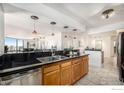 Open kitchen with a breakfast bar, tiled floors, and cabinetry at 1625 Larimer St # 2601, Denver, CO 80202