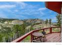Relaxing deck with patio seating overlooking a mountain landscape, ideal for outdoor living at 1629 Gold Run Rd, Boulder, CO 80302