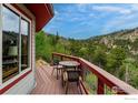 Charming deck with outdoor furniture and stunning forest views from the octagonal home at 1629 Gold Run Rd, Boulder, CO 80302