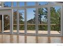Bright living room features a wall of windows and access to an outdoor deck at 1629 Timber Ln, Boulder, CO 80304