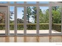 Bright living room features a wall of windows and access to an outdoor deck at 1629 Timber Ln, Boulder, CO 80304