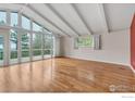 Spacious living room with hardwood floors, vaulted ceilings and walls of windows at 1629 Timber Ln, Boulder, CO 80304
