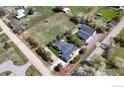 Aerial view of a large property with a house, outbuildings, and generous yard space at 1720 Chaparro Cir, Berthoud, CO 80513