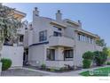 Exterior elevation featuring balconies, stucco facade, roof details and mature landscaping at 1825 Kendall St # 104, Lakewood, CO 80214