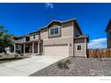 Lovely home featuring a spacious driveway, tidy landscaping, and great curb appeal at 2325 Mountain Sky Dr, Fort Lupton, CO 80621