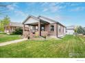 Beautiful home featuring a well-maintained lawn and covered front porch, perfect for relaxing at 304 E Nebraska Ave, Berthoud, CO 80513