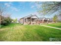 Quaint home with a large lawn and cozy front porch, ideal for enjoying the outdoors at 304 E Nebraska Ave, Berthoud, CO 80513