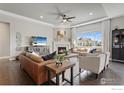 Spacious living room with hardwood floors, a fireplace, and plenty of seating at 3692 Deacon Dr, Mead, CO 80542