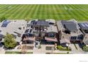 An aerial view of modern townhomes featuring solar panels and a nearby soccer field, showcasing urban living at 3734 Ridgeway St, Boulder, CO 80301